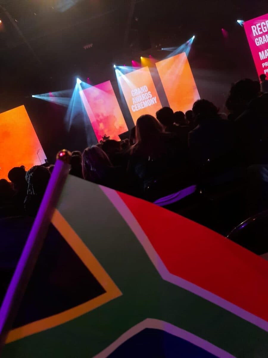 The ISEF Grand Awards Ceremony, with a South African flag held up in the foreground.