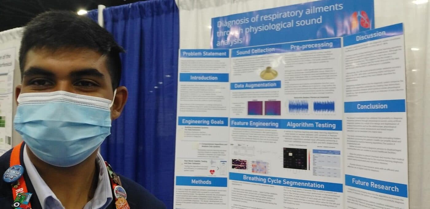 Sachin standing at his ISEF poster, titled 'Diagnosis of respiratory ailments through physiological sound analysis'.